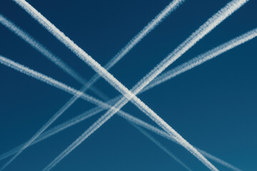Intersecting Airplane Contrails in Clear Blue Sky