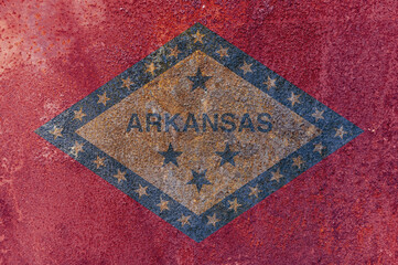 Arkansas State Flag. Dirty Arkansas state flag on rusty metal surface.