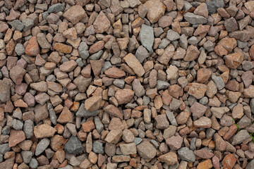Close-up of porphyry aggregate, construction crushed stone. Natural building material, suitable for road construction, landscaping, and concrete production