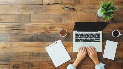 Female hands typing on laptop near coffee, plant, notes, glasses, wooden desk, top down perspective, workspace elements