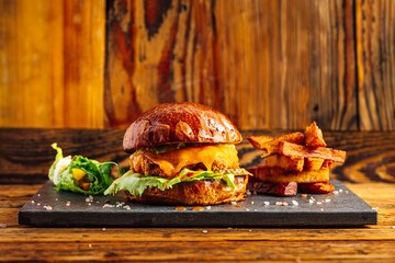 Craft burger with melted cheese on a rustic background