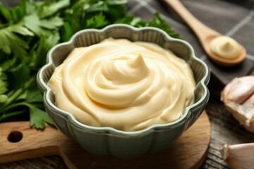 Delicious mayonnaise sauce in bowl on table, closeup