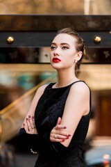 Young female model in black dress in Breakfast at Tiffany's style