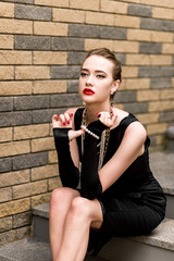 Young female model in black dress in Breakfast at Tiffany's style