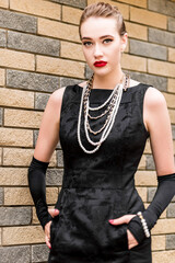 Young female model in black dress in Breakfast at Tiffany's style