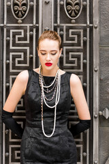 Young female model in black dress in Breakfast at Tiffany's style