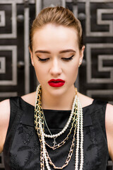 Young female model in black dress in Breakfast at Tiffany's style