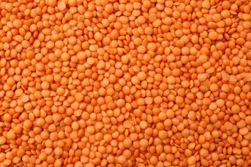 Raw red lentils as background, closeup view