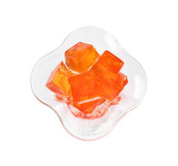 Tasty orange jelly cubes in dessert bowl isolated on white, top view