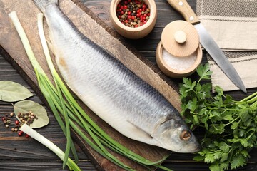 Tasty herring with spices on wooden table, flat lay