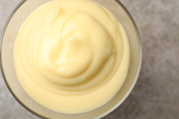 Tasty vanilla pudding on grey table, top view
