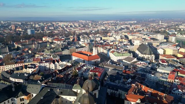 Olomouc, Czech Republic: Aerial forward footage of the ancient Olomouc town hall with the Astronomical Clock and the Church of St. Maurice in the old town in Czech Republic in a early morning light.