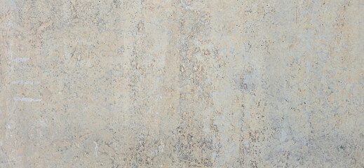 Old concrete wall with uneven color. Gray background with traces of peeling paint. Cement wall traces of scratches, The retro style wall has an antique beauty.
