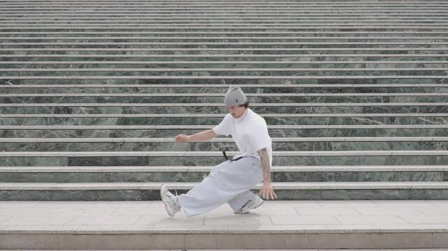 Breakdancer performing various moves on urban steps