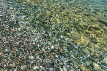 Pebble coast and waves in Datca, Turkey.  Clear water of the Mediterranean coast of Turkey.
