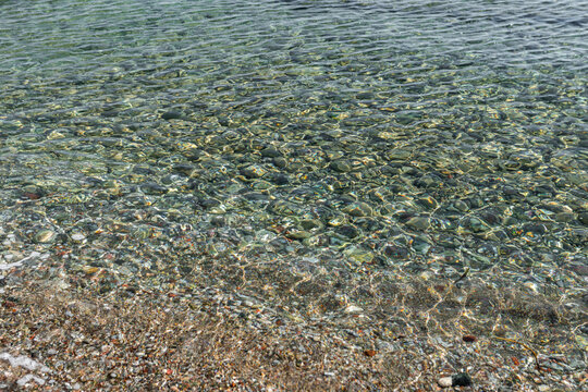 Pebble coast and waves in Datca, Turkey.  Clear water of the Mediterranean coast of Turkey.