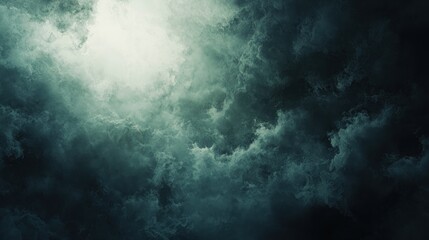 Dark, stormy clouds with a bright light breaking through.