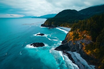 Fototapeta premium Turquoise ocean waves crashing on rocky coastline with lush green forest