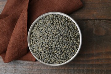 Raw green lentils on wooden table, top view