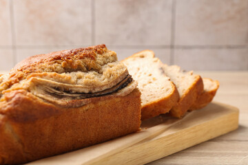 Cut banana bread on wooden table, closeup