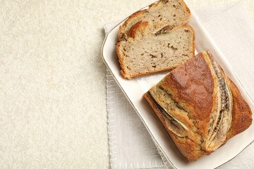 Cut banana bread on light grey table, top view. Space for text