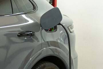Charging for electric car with a public charger in a parking.Station of power cable pump plug in...
