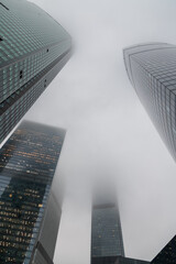 Skyscrapers vanish into thick fog on a misty morning in the city
