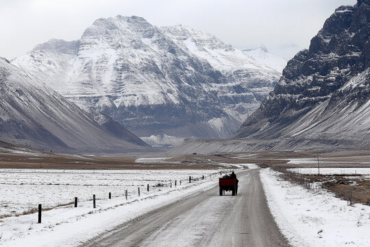 Chukchi people navigating snowy terrain surrounded by dramatic mountain peaks in remote landscape