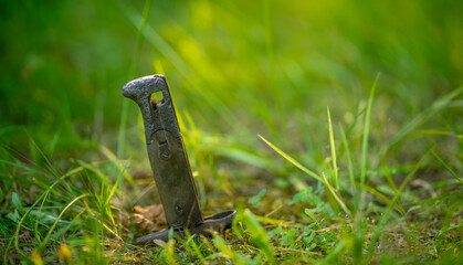 The handle of the knife sticks out of the ground. The place of the military clash in the field.Search for missing warriors.