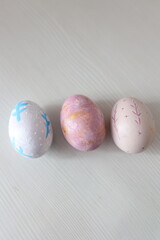Colorful Easter eggs with hand-painted floral patterns on a light background. Spring atmosphere, festive decoration, and Easter traditions.