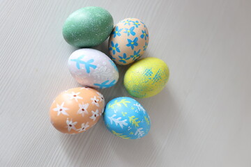 Colorful Easter eggs with hand-painted floral patterns on a light background. Spring atmosphere, festive decoration, and Easter traditions.