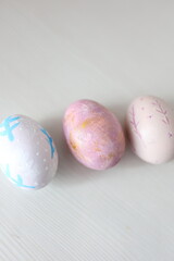 Colorful Easter eggs with hand-painted floral patterns on a light background. Spring atmosphere, festive decoration, and Easter traditions.