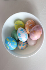Colorful Easter eggs with hand-painted floral patterns on a light background. Spring atmosphere, festive decoration, and Easter traditions.
