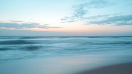 Obraz premium Soft pastel sunrise over tranquil ocean shore