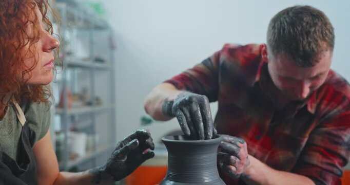 Creative pottery session with skilled artists crafting unique vases in a cozy studio setting during daylight hours