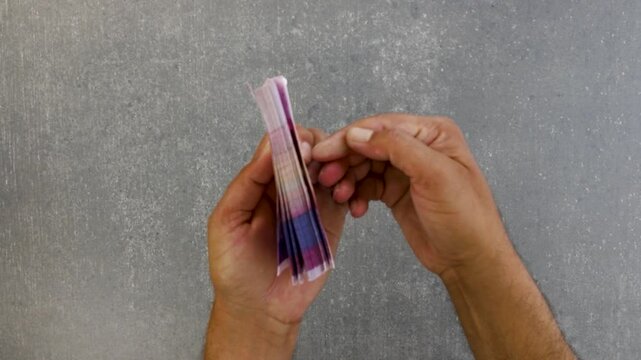 Hands Count Money. Counting Pakistan fifty rupees notes. Close-up view