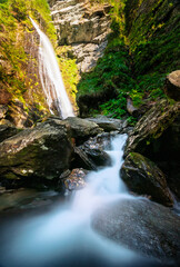 Fototapeta premium waterfall in the alps with cascade river flow in front long exposure
