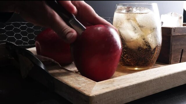Making Apple Butterscotch Cocktail with apple whiskey, butterscotch schnapps, club soda and lots of ice.  A delicious adult beverage for hot summer days.  Mixing up cocktails at a party. Autumn drinks