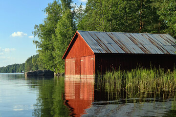 Wooden red boathouse in Sorsakoski, Leppavirta, Finland