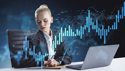Businesswoman analyzing data on futuristic financial interface with digital graphs and charts on dark world map background using laptop and notebook.