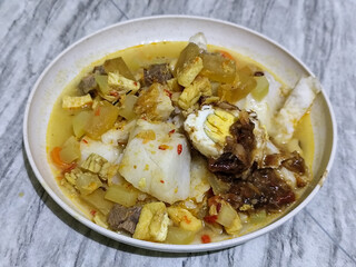 Ketupat Lebaran. Chicken vegetable ketupat is a typical Indonesian dish that is famous for its deliciousness and has a special place in Indonesian culinary culture