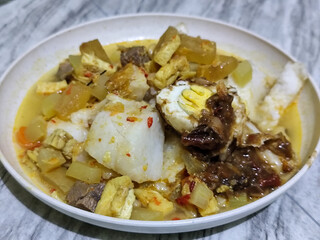 Ketupat Lebaran. Chicken vegetable ketupat is a typical Indonesian dish that is famous for its deliciousness and has a special place in Indonesian culinary culture