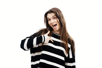 Young brunette with a smile, pointing her finger at herself on a white background. Concept of...