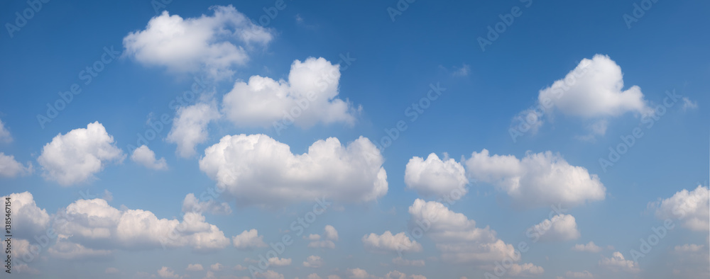 Poster the sky is blue with many clouds. the clouds are white and fluffy. the sky is clear and bright