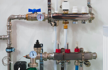 A pipe with a red and white valve and a white and red valve. The valves are connected to a pipe with a red and white gauge