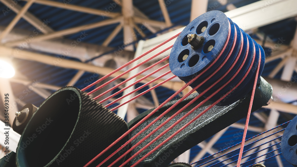 Aufkleber a blue and red pulley system is suspended from the ceiling. the pulley system is made of ropes and i