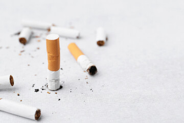 Many cigarette butts on light background, space for text