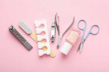 Set of different manicure tools on pink background, flat lay