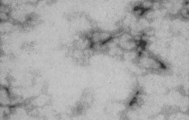 Abstract white pattern on dark surface with gray noisy background and lo-fi textured effect. Monochrome grainy image with blurred backdrop for creative poster, cover, flyer, template banner design