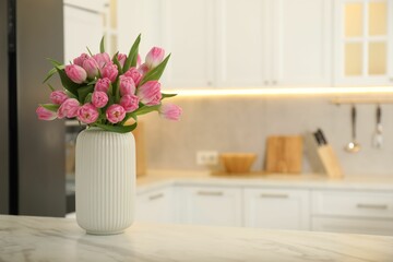 Bouquet of beautiful tulips in vase on white marble table indoors, space for text